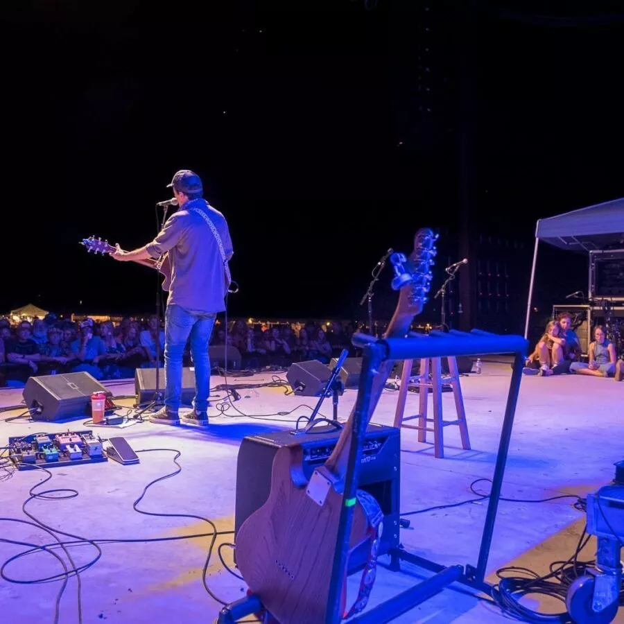 Jason Mraz with Guthrie Family watching from Stage Right — 21st Annual Woody Guthrie Festival, 2018