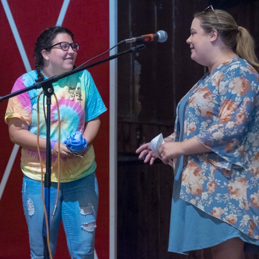 Riley Accepts a T-Shirt As Part of Her Prize Package — Kids’ Songwriting Contest Awards Announcement, 21st Annual Woody Guthrie Festival, 2018