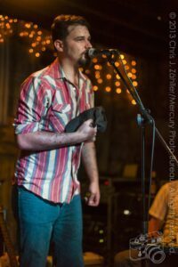 Riley (III) (Hat in Hand) — Sam Doores + Riley Downing & the Tumbleweeds at the Brick Café, Woody Guthrie Folk Festival 16