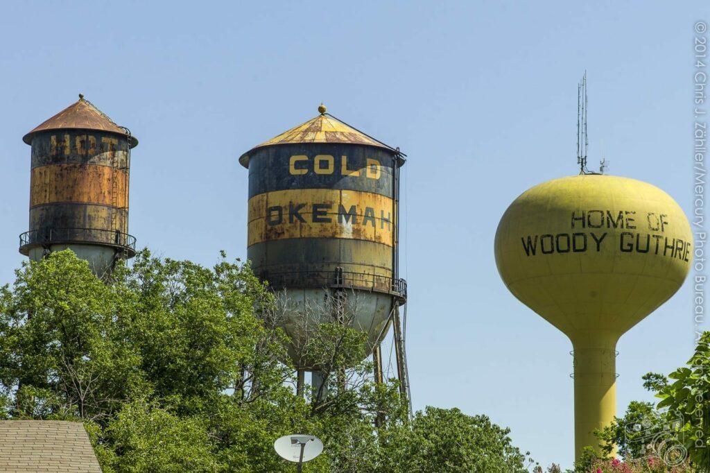 Water Tower (I) — The famous triple water towers in Okemah, Oklahoma. The city cannot afford to repair the two older towers, each nearly a century old, & may demolish them in 2015.